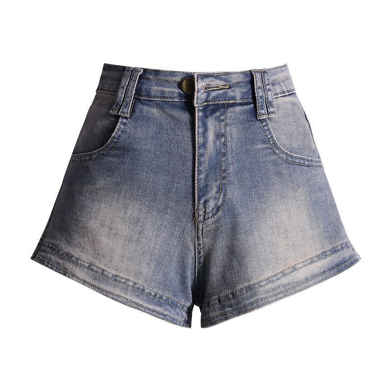 High waist vintage blue denim shorts with rolled hems displayed against white background.