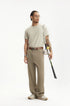 Man wearing khaki mens dress pants with white sneakers and brown belt