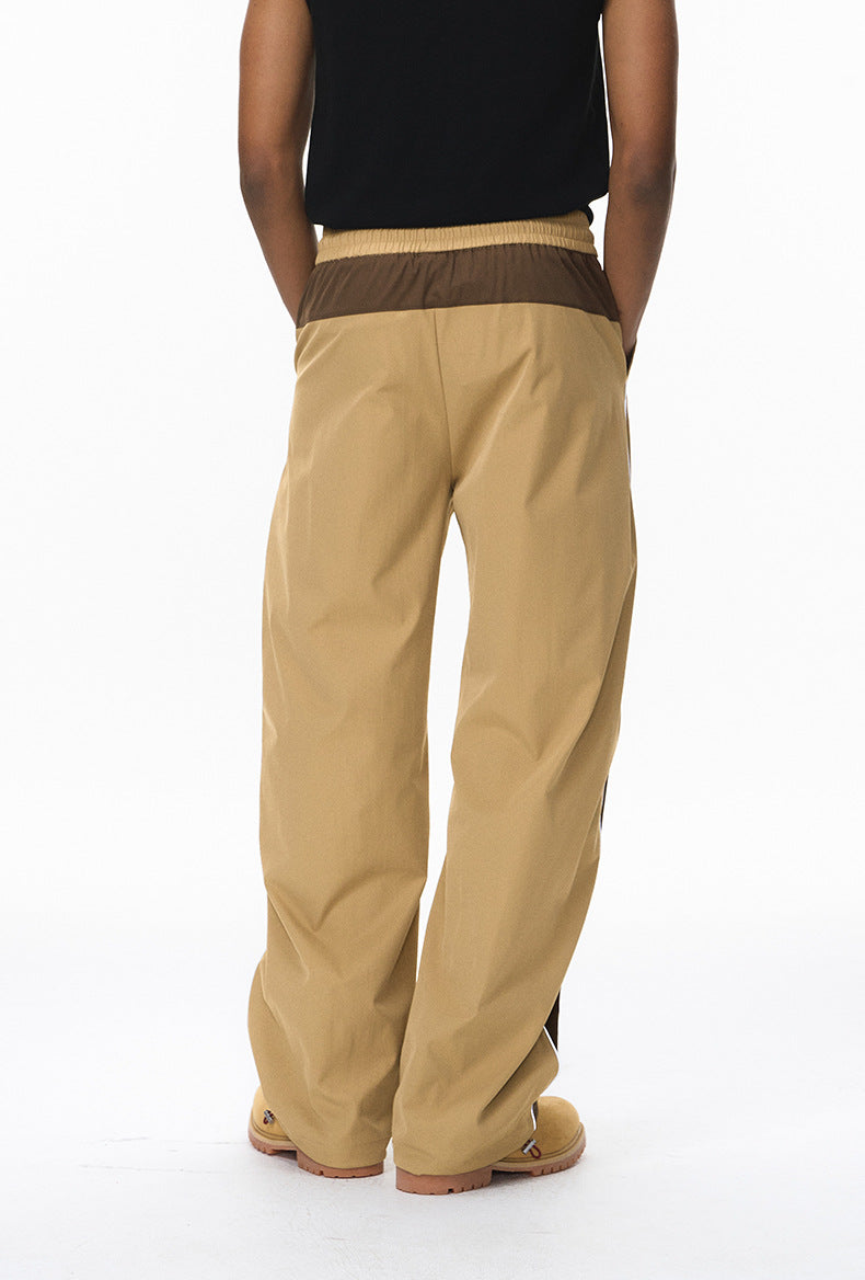 Khaki wide leg track pants back view, elastic waist and pockets