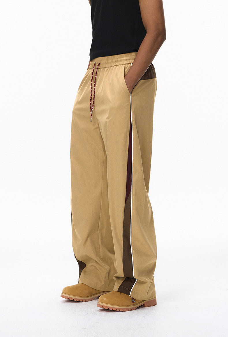 Khaki wide leg track pants side view with hand in pocket