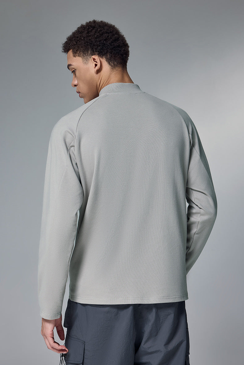 Back view of a light gray half-zip long sleeve tshirt on a gray background