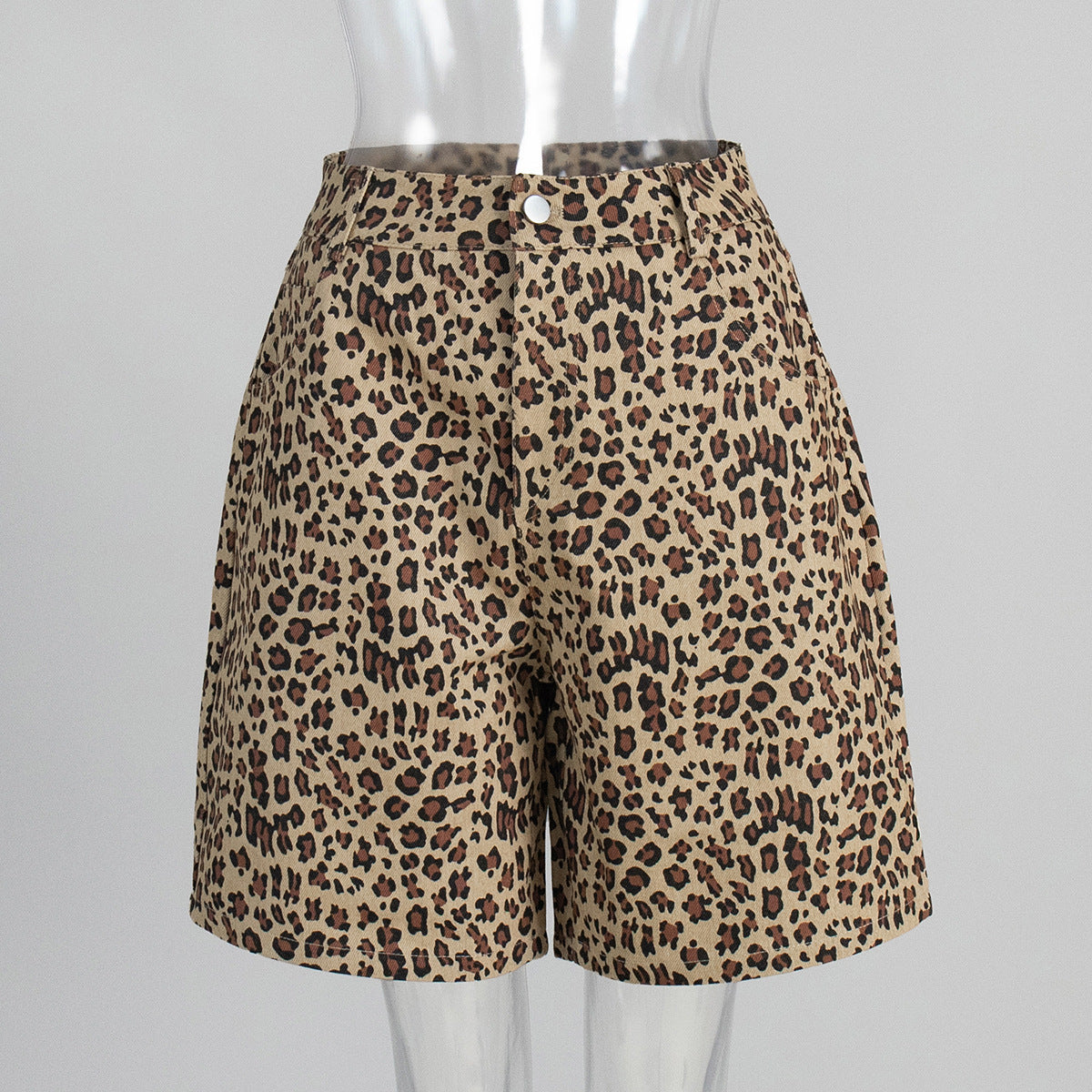 Beige leopard print cotton shorts with front pockets and button closure in mannequin
