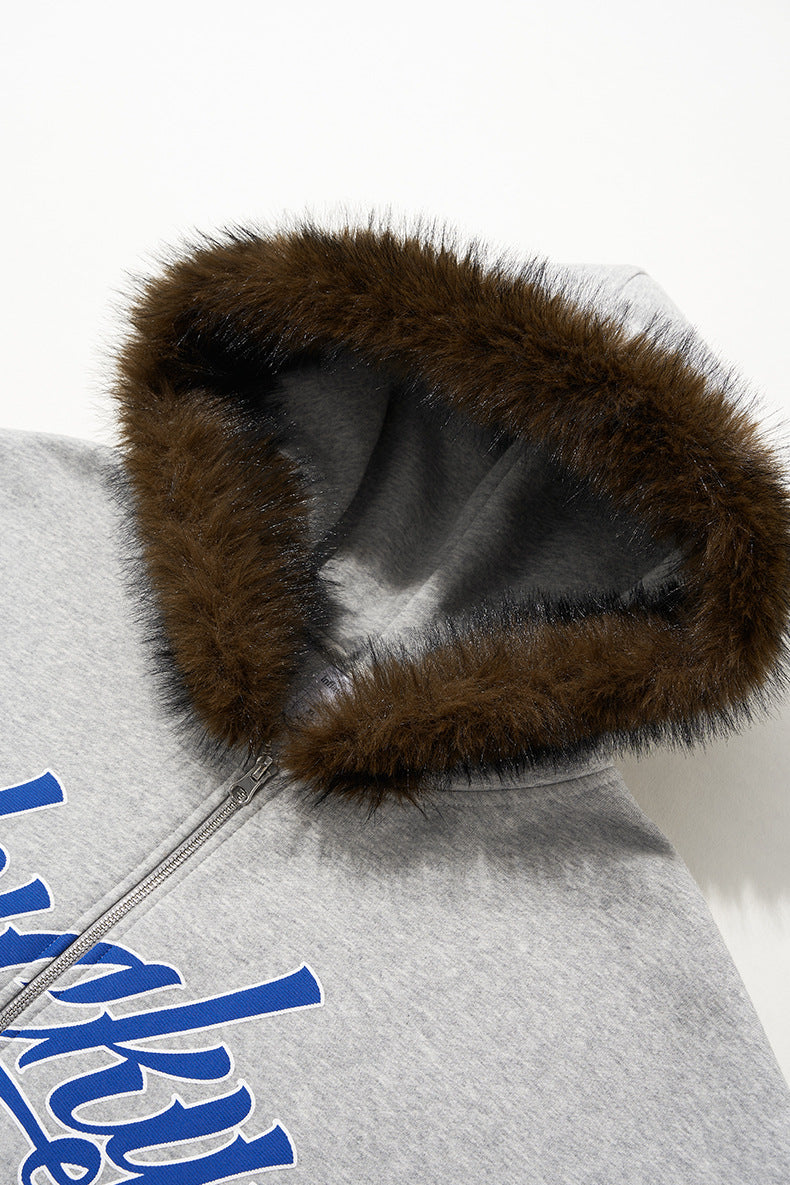 Plush fur hood trim on gray jacket, macro detail.