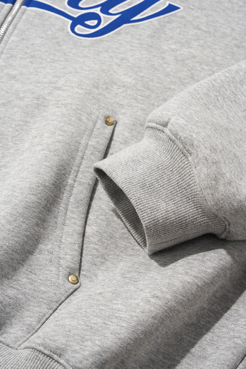 Gray jacket sleeve cuff and snap detail, close-up.