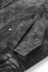 Pocket flap with snap close-up on dark gray bomber jacket