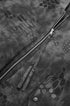Sleeve zipper and puller detail close-up on dark gray bomber jacket