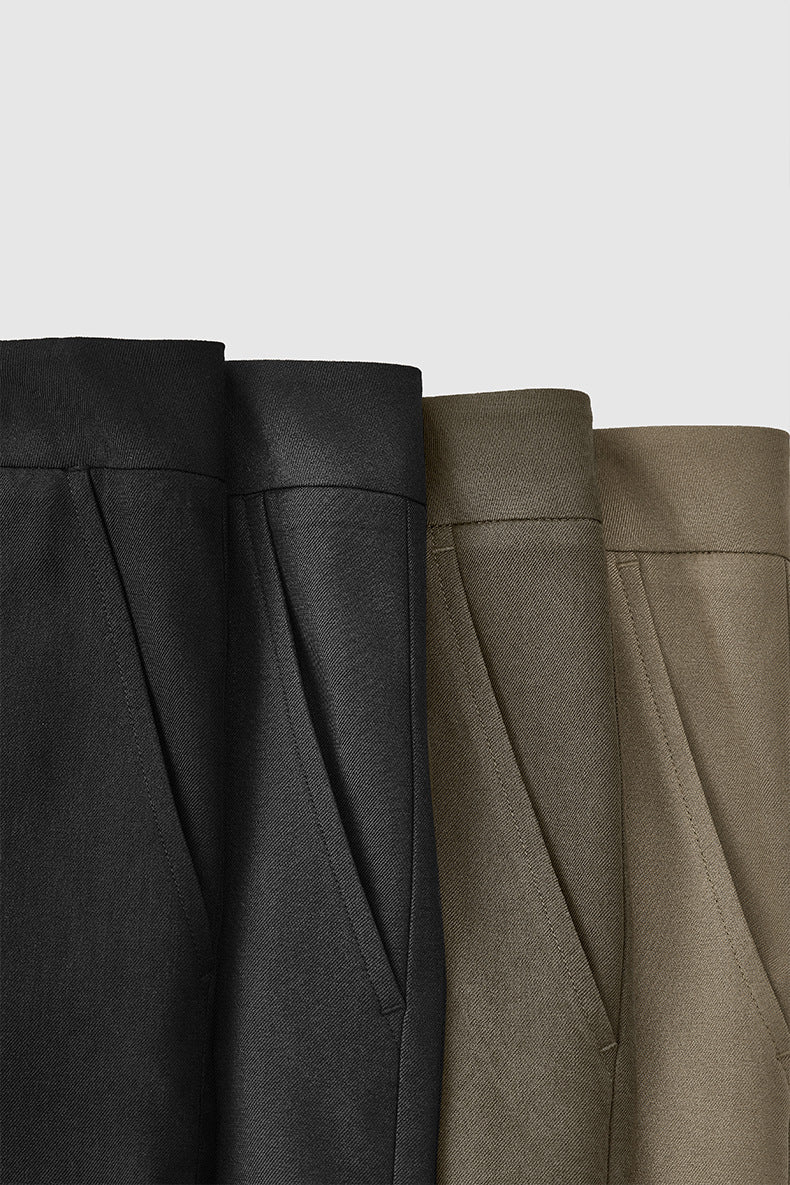 Close-up of mens dress pants fabric in black, khaki, and dark gray, brown colors.