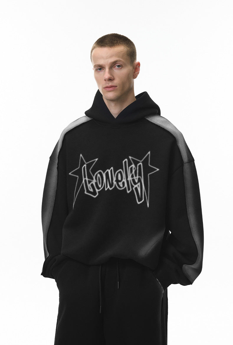 Black graphic hoodie on model, relaxed fit with drop shoulders, front.