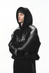 Side view of black graphic hoodie on model showing drop shoulder.