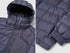 Puffer jacket zipper pull and storm flap close-up