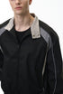 Black racing jacket half-body front, collar snap detail and zip