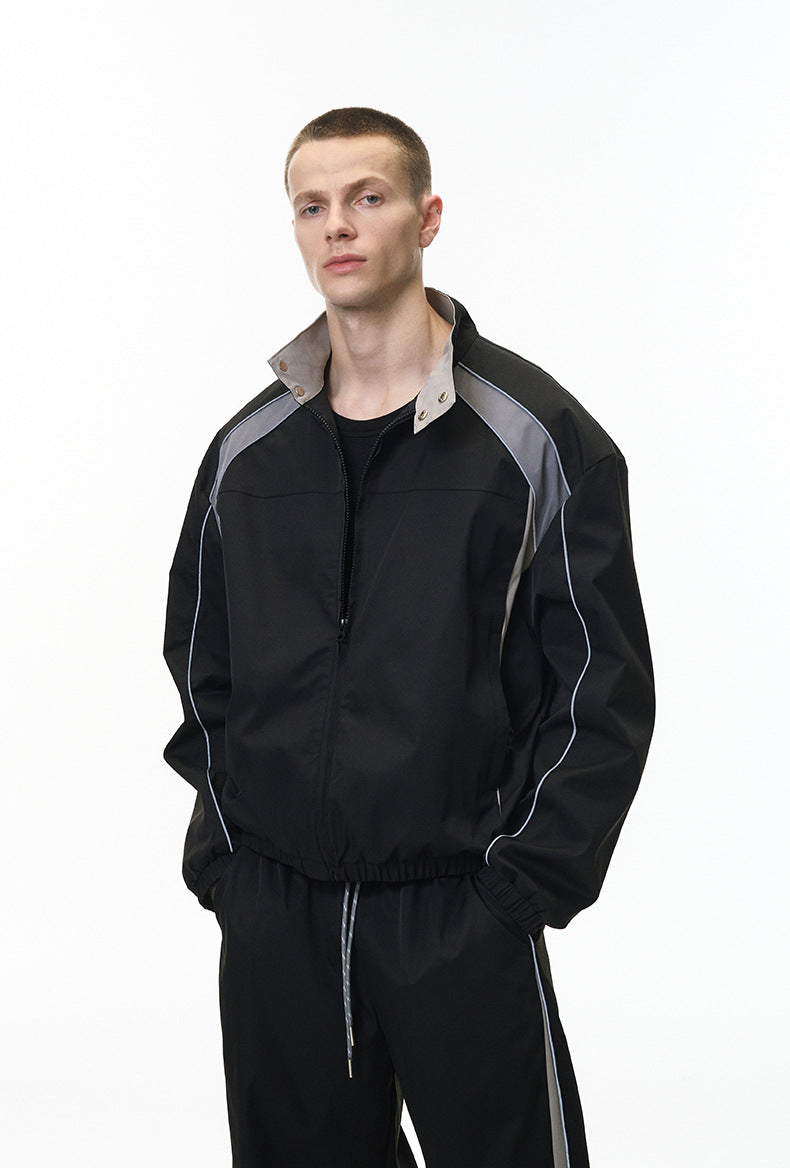 Black racing jacket front view on model, contrast panels, tracksuit top