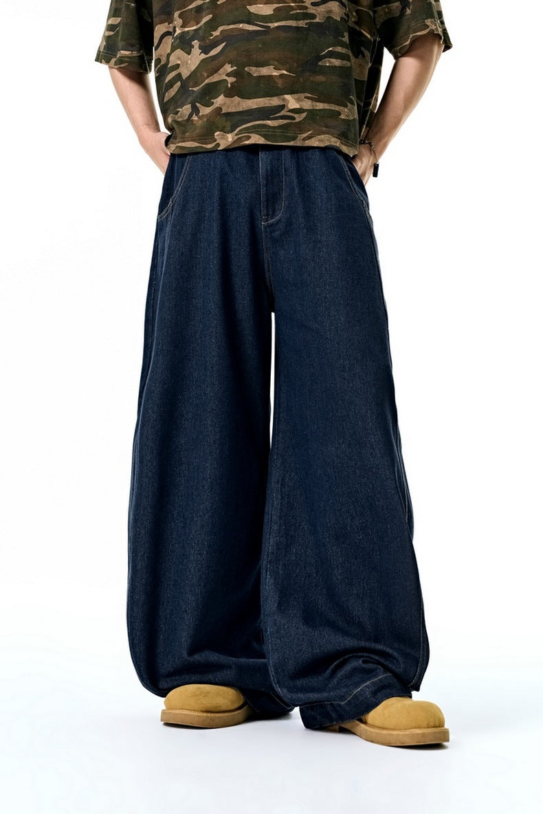 Person wearing dark blue wide-leg jeans and a camouflage shirt on a white background
