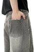 Light gray wide leg jeans three-quarter pose with hands in pockets