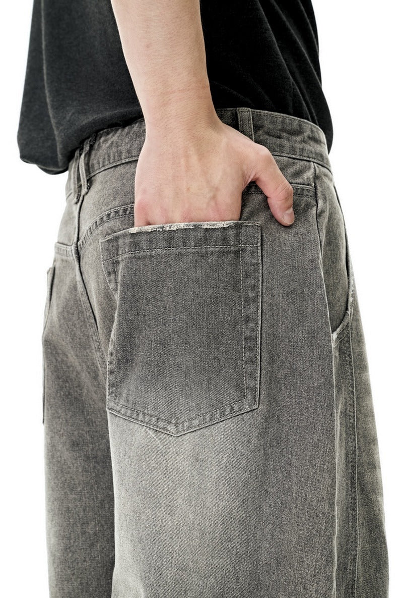 Light gray wide leg jeans three-quarter pose with hands in pockets