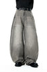 Wide-leg gray jeans worn by a person on a white background