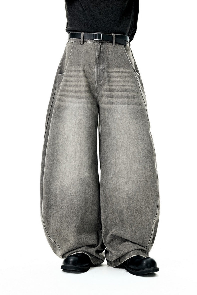 Wide-leg gray jeans worn by a person on a white background