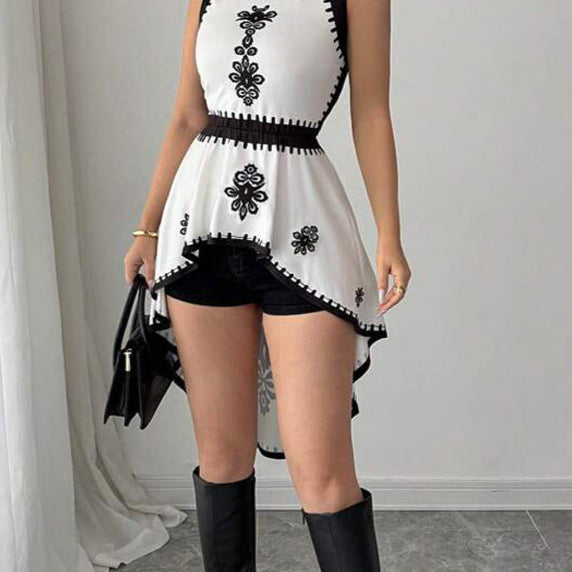 Close-up of black contrast floral details on white sleeveless peplum blouse
