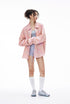 Pink plaid shirt three-quarter view, curved hem and long sleeves