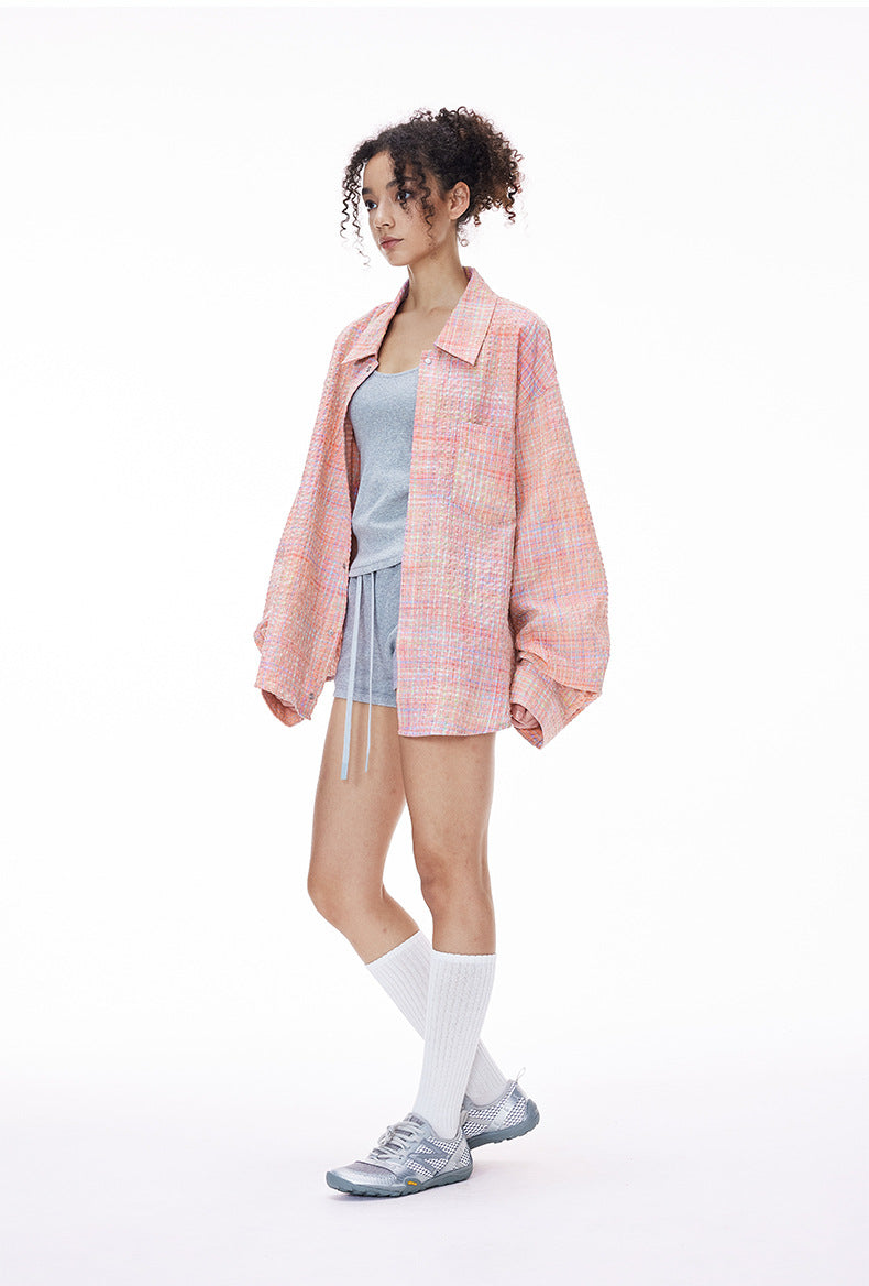 Pink plaid shirt side view on model, relaxed drop shoulder