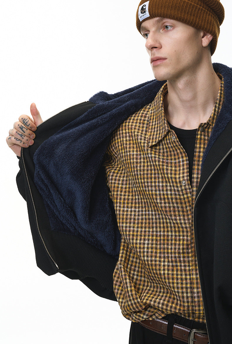 Black plush zip jacket, inner plaid layer reveal.