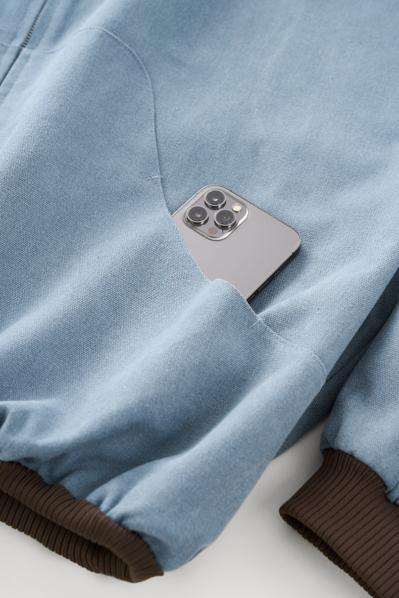 Blue plush zip jacket, hem label and stitching detail.