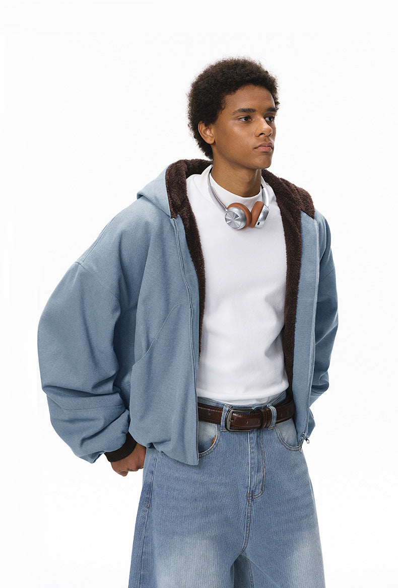 Blue plush zip jacket, relaxed fit, hands in pockets.