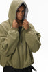 Green plush zip jacket, hood adjust, on-body portrait.