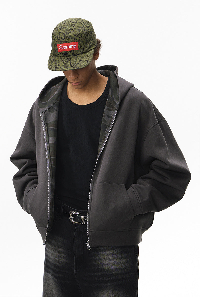 Reversible hoodie, dark gray side—hands in pockets, casual stance