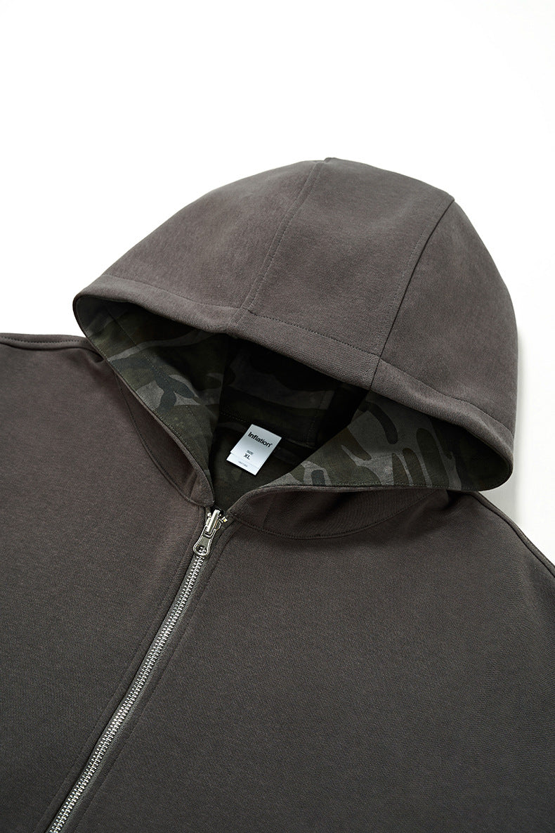 Reversible hoodie detail—hood and zipper close-up, clean edges both sides