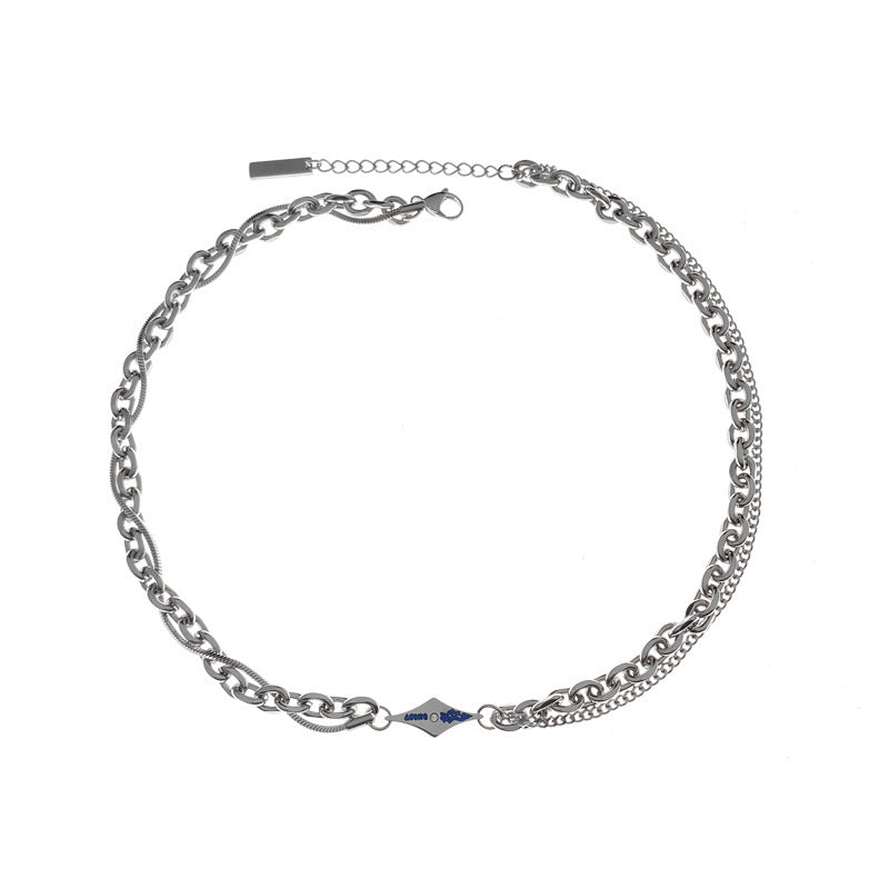 Silver necklace with dual chains and engraved blue tag on white background.