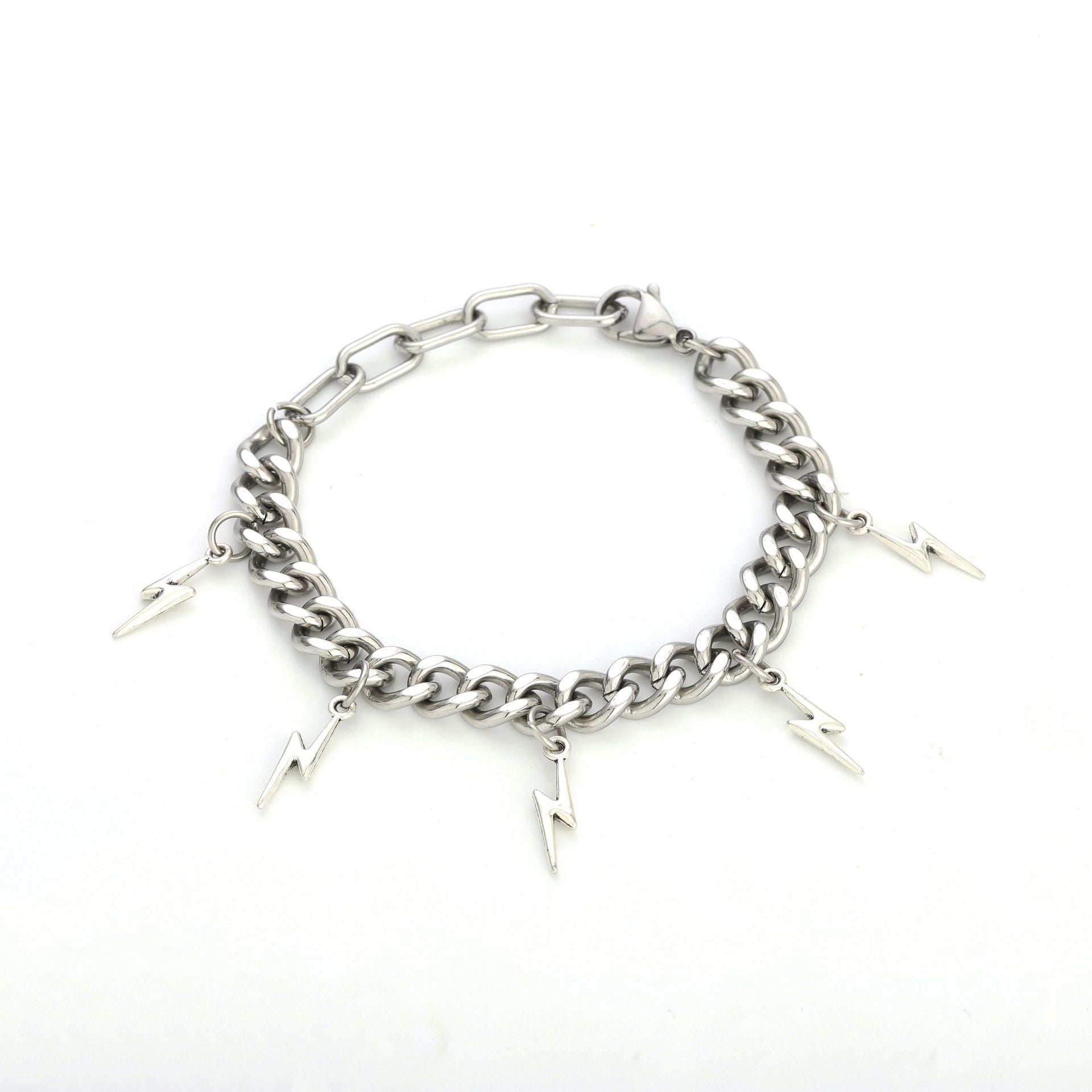 Silver bracelet with lightning charms laid out on white background.