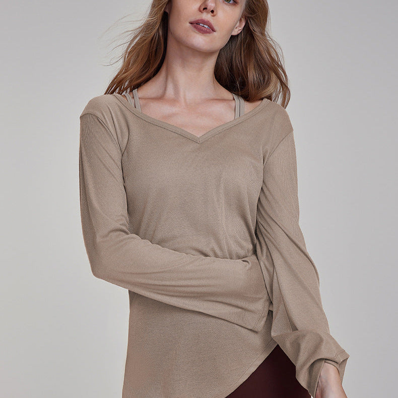 Woman wearing a khaki V-neck long sleeve yoga top with drawstring side detail.