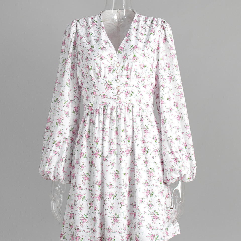 White floral mini dress with v-neck and balloon sleeves on clear mannequin.