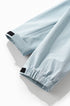 Sky blue windbreaker jacket cuff tab and sleeve hem detail