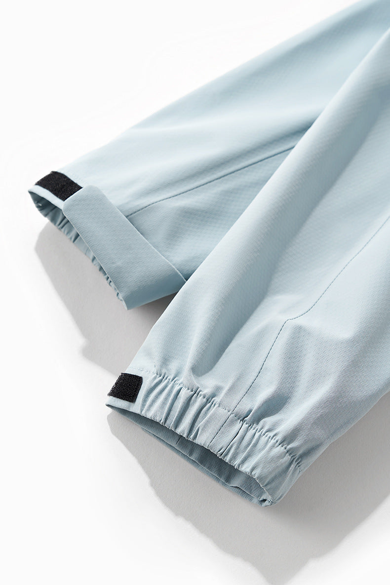 Sky blue windbreaker jacket cuff tab and sleeve hem detail