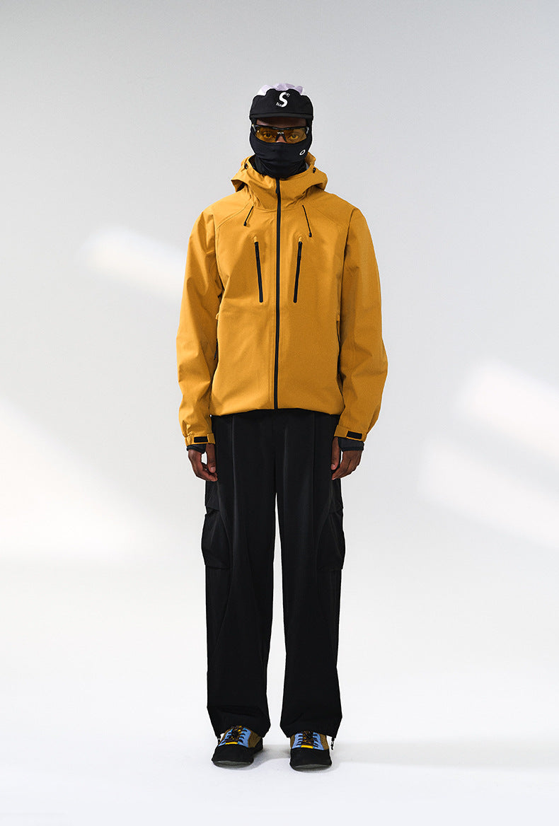 Yellow windbreaker jacket front view on model, hooded and relaxed fit