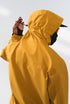 Yellow windbreaker jacket three-quarter back view on model