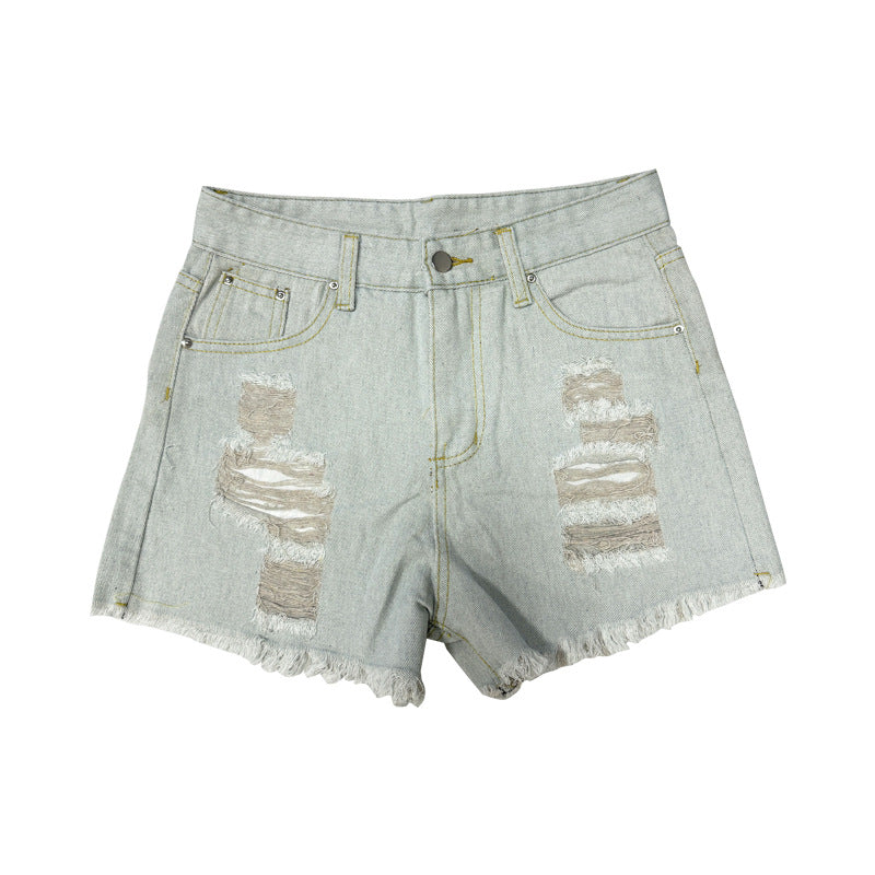 Front view of distressed light wash denim shorts with heavy ripped details and frayed hems.