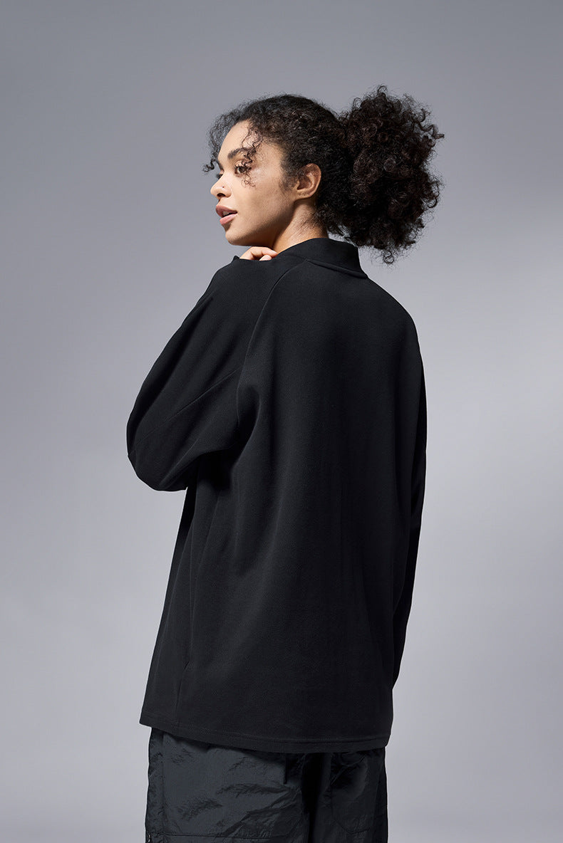 Angled view of black half zip long sleeve t shirt for women relaxed fit