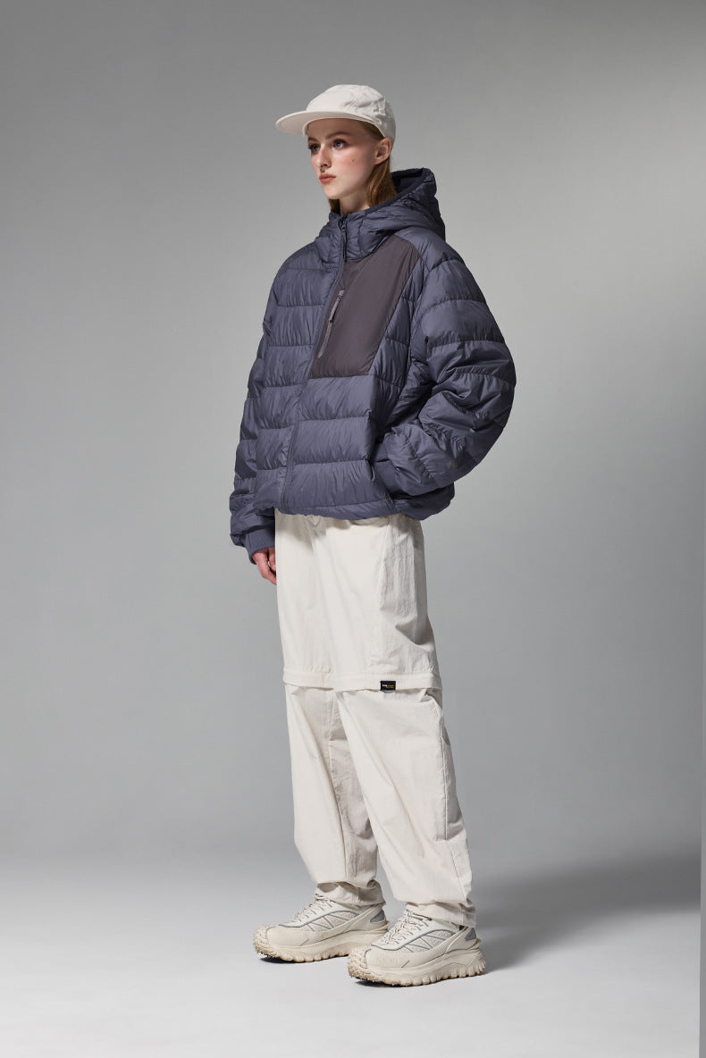 Navy blue women’s puffer jacket front on model, hooded down coat