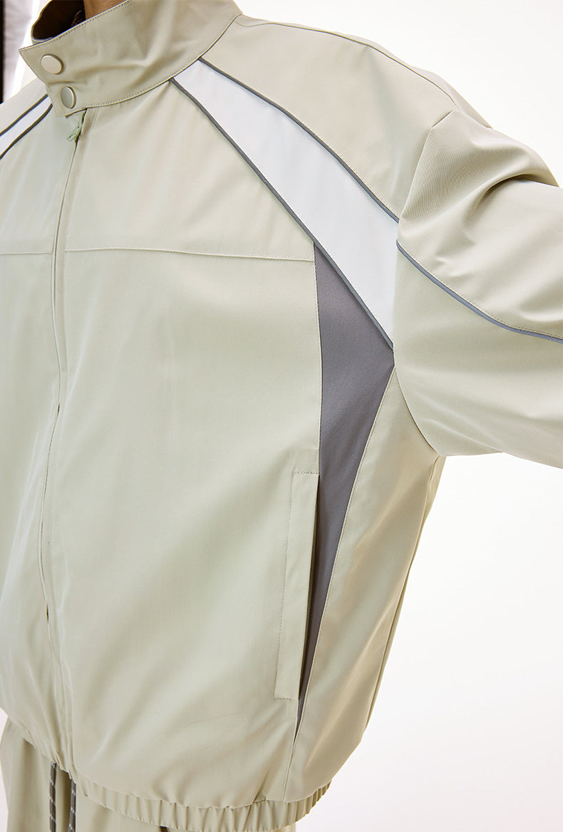 Light gray racing jacket chest zip and piping detail close-up