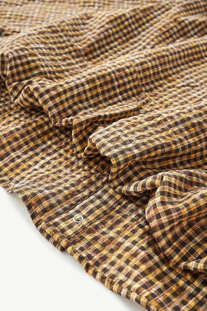 Yellow plaid shirt gathered fabric close-up, soft seersucker