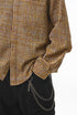 Yellow plaid shirt pocket and button close-up