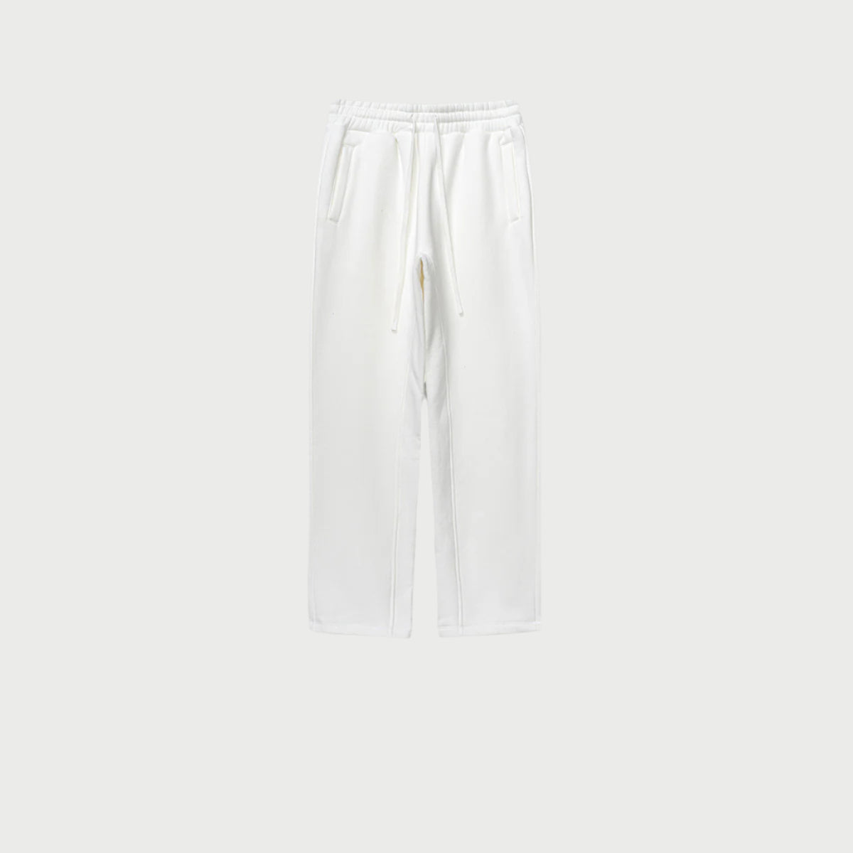 White sweatpants with elastic waistband, drawstring and side pockets displayed on light gray background