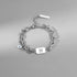 Taurus zodiac charm bracelet with a silver-tone layered chain and an engraved zodiac symbol pendant.