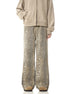 A model wearing beige zip-up hoodie and leopard print wide-leg pants standing against white background, showing full-length outfit view