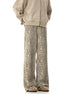 Back view of a model wearing beige zip-up hoodie and leopard print wide-leg pants, showing rear detail against white background