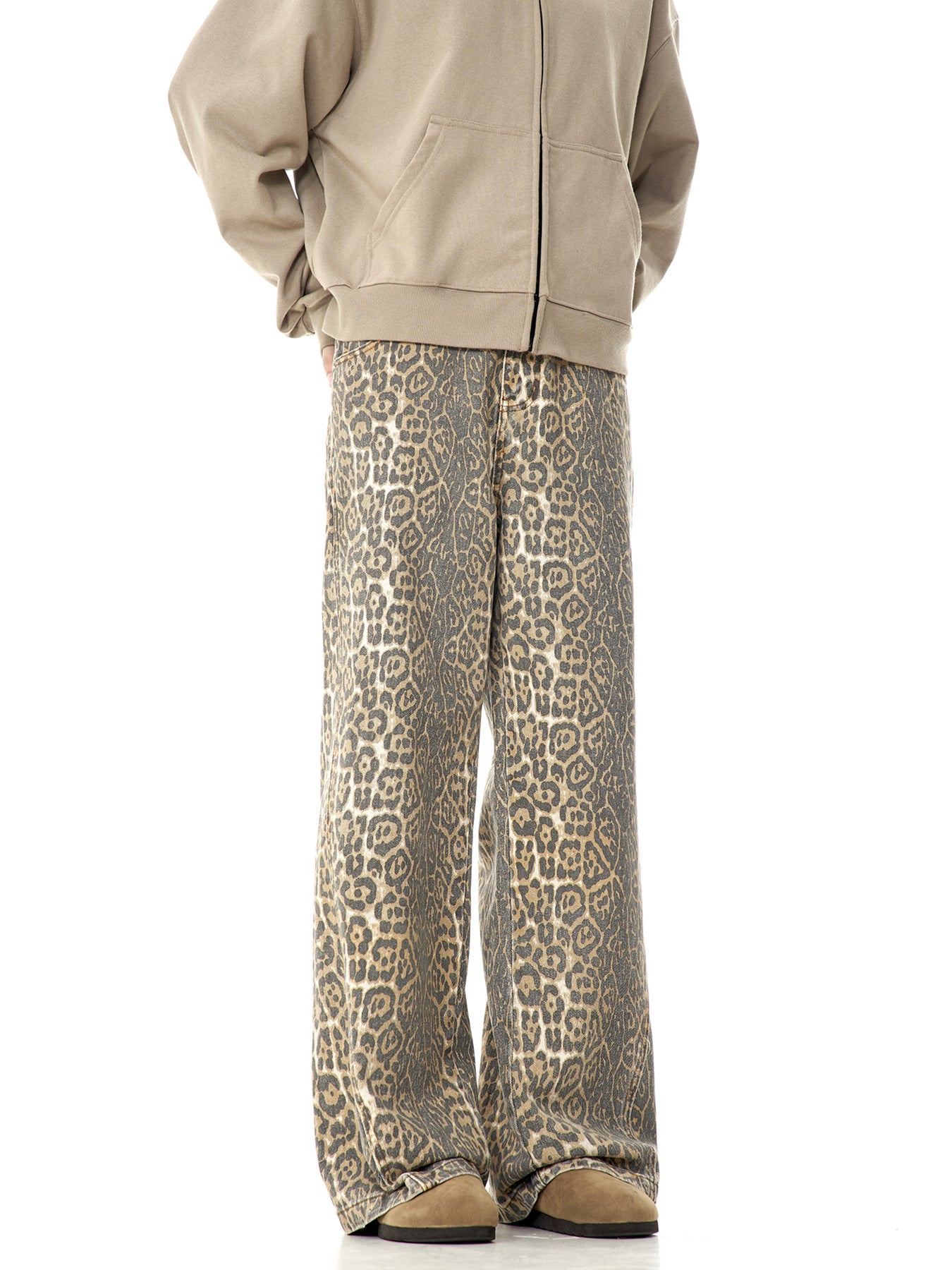 Back view of a model wearing beige zip-up hoodie and leopard print wide-leg pants, showing rear detail against white background