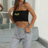 Black tube top with embroidered sunflowers paired with grey sweatpants